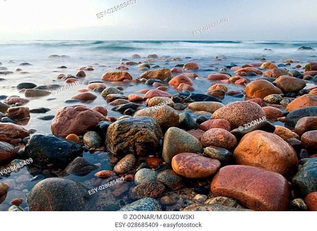 Stony calm Baltic beach seascape after sunset