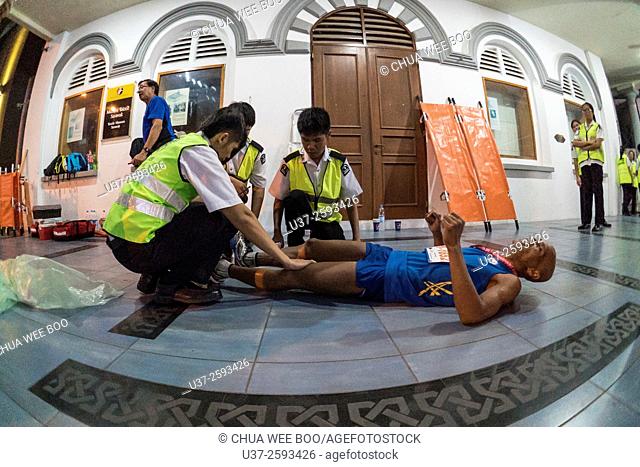 First aid on marathon runner after legs cramped in Kuching, Sarawak, Malaysia