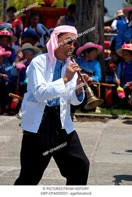 China: A Bai man plays a Chinese suona (oboe), Bai music and dance festival at Santa Si (Three Pagodas), Dali, Yunnan