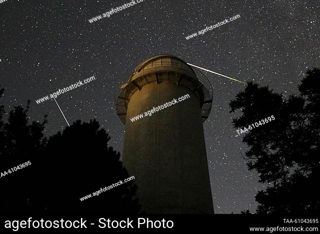 RUSSIA, REPUBLIC OF CRIMEA - AUGUST 12, 2023: A view of falling stars of the Perseid meteor shower in the sky over the Crimean Astrophysical Observatory in the...