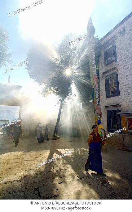 A buddhist monk walk in the smoky courtyard of the Ramoche Monastery  lhasa  lhasa prefecture  tibet  china  asia