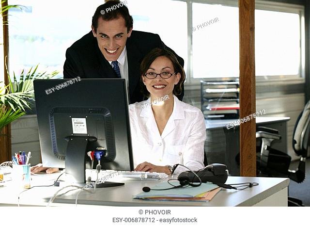 Business duo working in front of a computer