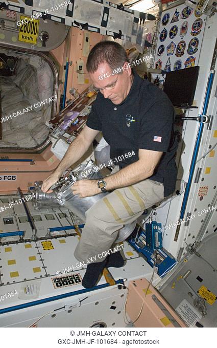 NASA astronaut Kevin Ford, Expedition 33 flight engineer, performs in-flight maintenance on the Waste and Hygiene Compartment (WHC) toilet facilities in the...