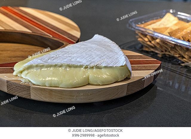 A Wedge of French Brie Cheese, Room Temperature, Crackers in the Background, NYC