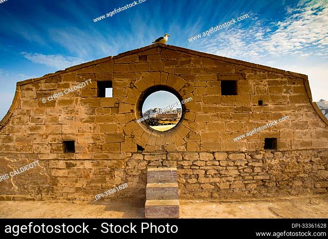 Circular window in the wall of the Sqala du Port walkway to the Essaouira Citadel; Essaouira, Morocco