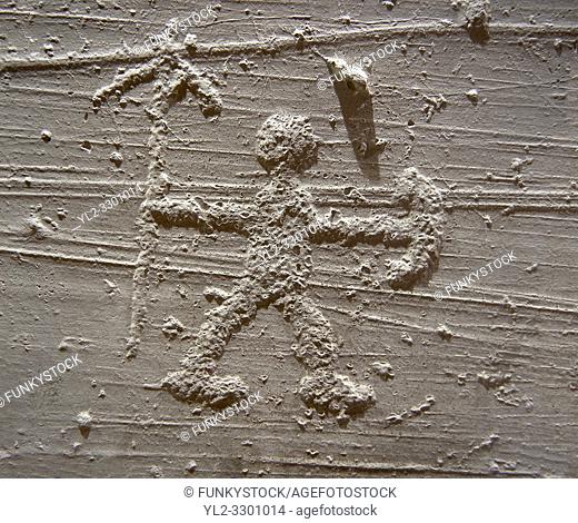 Cast of a prehistoric Petroglyph, rock carving, of a warrior with a spear and shield carved by the Camunni people in the iron age between 1000-1600 BC