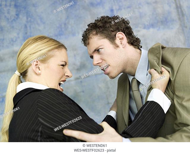 Businessman and businesswoman quarrelling