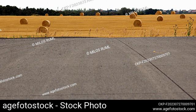 Closed road turn, unfinished road front of field with bale of straw during the grain harvest near Nupaky, Czech Republic, July 27, 2023