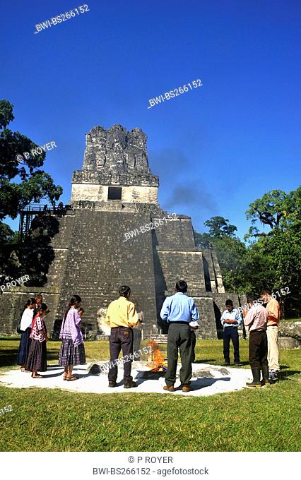 group of peole at a shamanic rite at the main square in front of the pyramid at the main square of the Maya city Tikal, Guatemala, Tikal