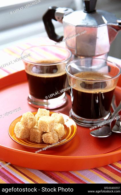 Two espressos, brown sugar and espresso pot