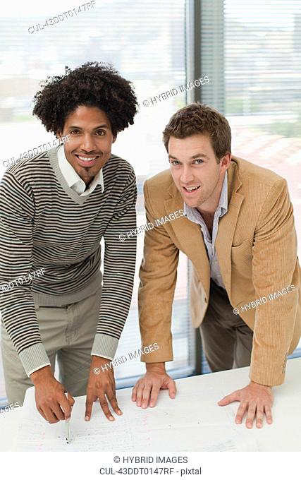 Businessmen smiling in meeting
