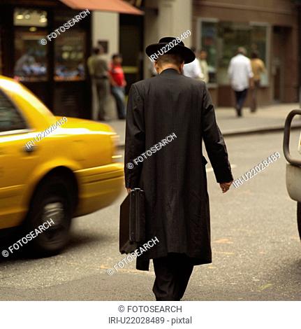 Man walking down street, New York City