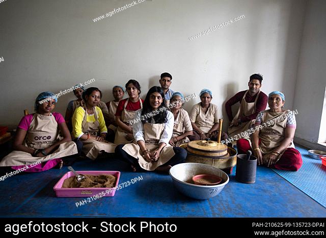 PRODUCTION - 21 June 2021, India, Neu Delhi: Adhvika Agarwal (M), founder of organic spice company ORCO, poses with her employees at the company's New...