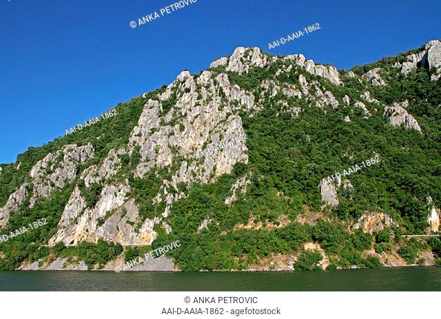 Rocky forest cliff on the Serbian bank of the Danube River, Border between Serbia and Romania, Tekija, Serbia