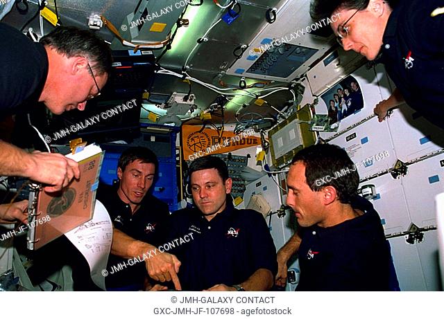 A planning session on Endeavour's mid deck includes all but one of the crew members. From the left are astronaut Jerry L. Ross, cosmonaut Sergei K