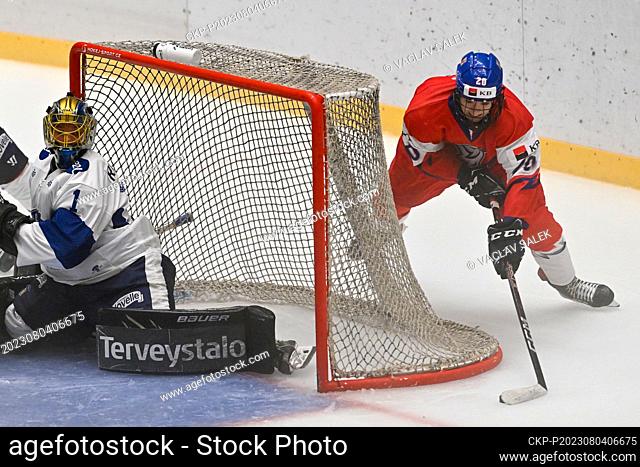 Finnish goalkeeper Petteri Rimpinen, left, and Ondrej Kos of Czech Republic in action during the Hlinka Gretzky Cup, annual under-18 hockey tournament