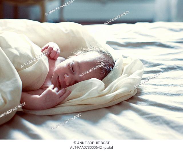 New born baby sleeping in bed