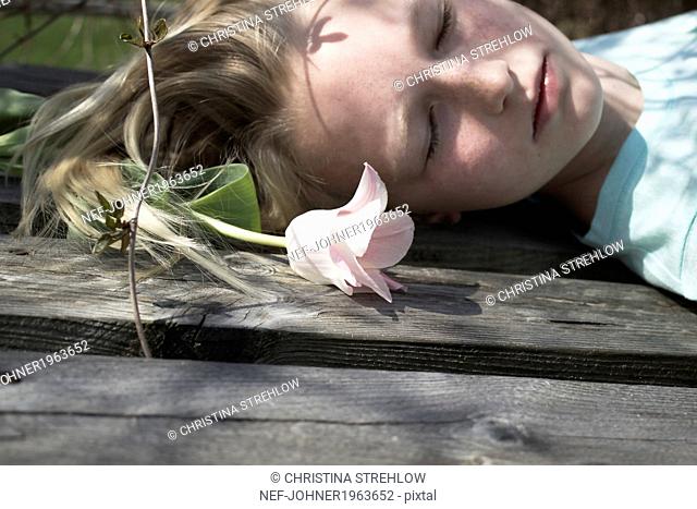 Girl lying down with flower