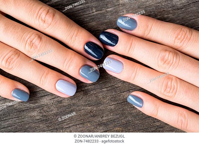 Beautiful hands with the miniature painted in a gray-colored