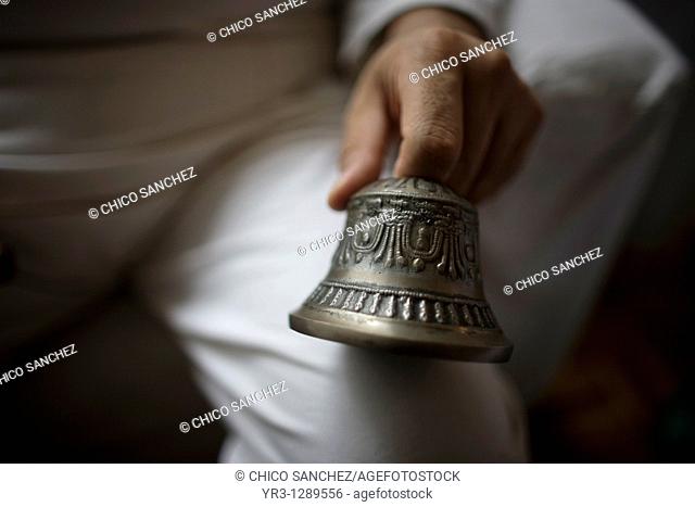 A Reiki Master holds a bell during a meditation in Mexico City. Reiki is a spiritual practice developed in 1922 by Japanese Buddhist Mikao Usui