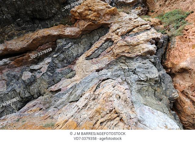 Lamprophyre dikes break through other rocks. This photo was taken in Costa Brava (Pals), Girona province, Catalonia, Spain