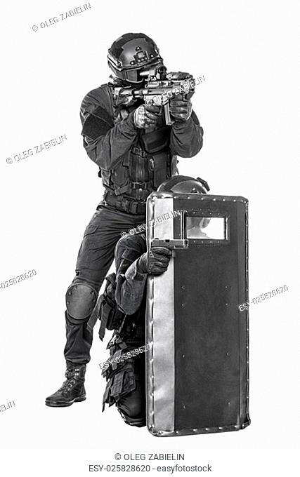 Spec ops police officer SWAT with ballistic shield studio shot
