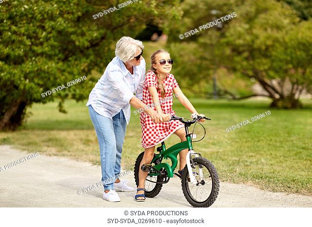 grandmother and granddaughter with bicycles