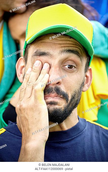 Football supporter crying at match