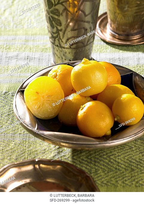 Pickled lemons in a metal bowl