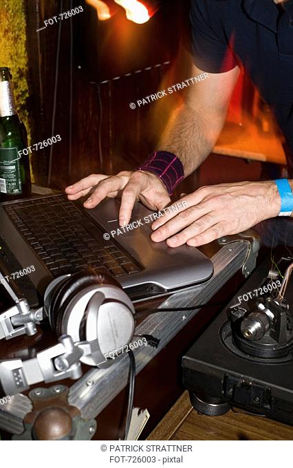 A DJ using his laptop