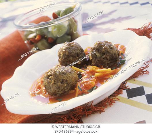 Meatballs on tomato & carrot sauce and bottled olives