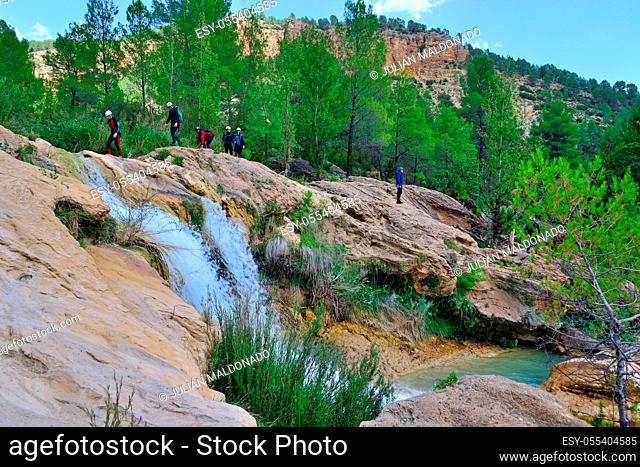 Enguidanos, Spain - September 2, 2018: Group of people practicing the activity of ravine