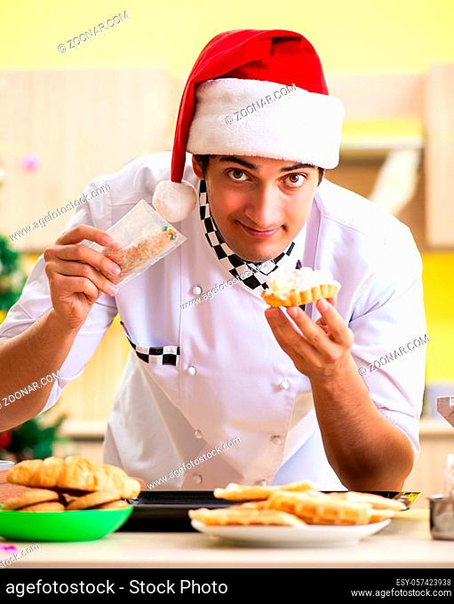 The young chef husband working in kitchen at christmas eve