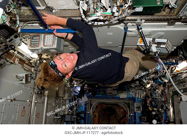 NASA astronaut Sandy Magnus, STS-135 mission specialist, is pictured in the U.S. lab or Destiny on the International Space Station during the fourth day in...