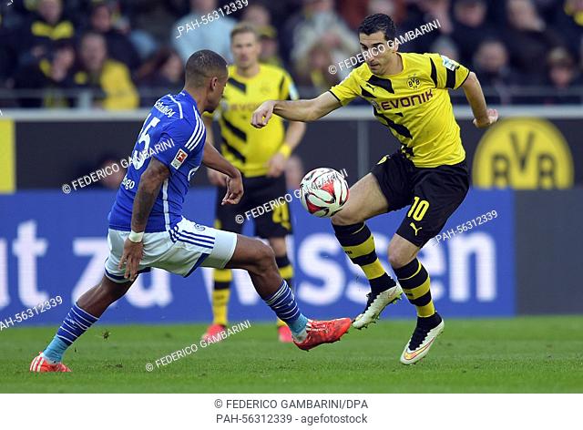 Dortmund's Henrikh Mkhitaryan (r) and Schalke's Dennis Aogo (l) in action during the Bundesliga soccer match Borussia Dortmund vs FC Schalke 04 in Dortmund