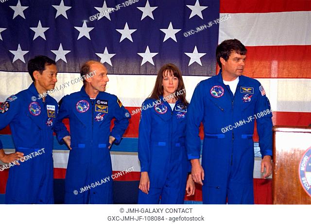 Four members of the STS-99 crew stand on stage in Ellington Field's Hangar 990 during welcoming ceremonies on February 23