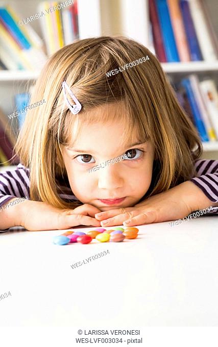 Portrait of little girl with chocolate buttons