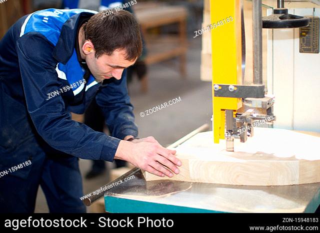 Belarus, the city of Gomel, on April 26, 2018. Furniture manufacturing. Open Day. Carpenter makes furniture with a machine.Furniture factory