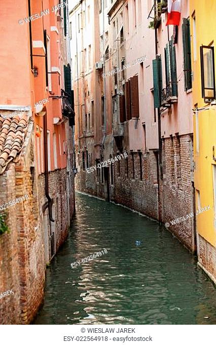 View of ancient buildings and narrow canal in Venice