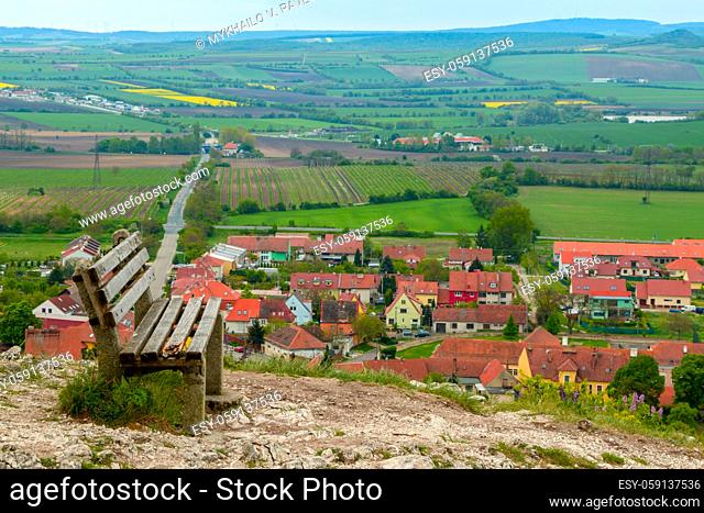 Czech Republic. An old bench on a hill overlooking a small town