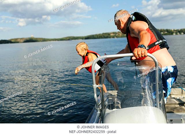 Grandfather with granddaughter on boat