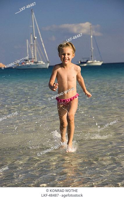 child running in water, Cala Brandinchi, Sardinia, Italy