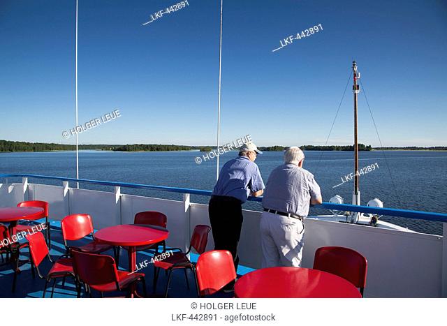 Two men on the deck of river cruise ship MS General Lavrinenkov (Orthodox Cruise Company), Svir river, Lake Onega, Russia, Europe