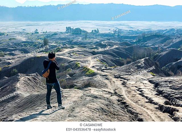 Man on top of Layer Volcanic ash as sand ground of Mount Bromo volcano (Gunung Bromo) at Bromo Tengger Semeru National Park, East Java, Indonesia