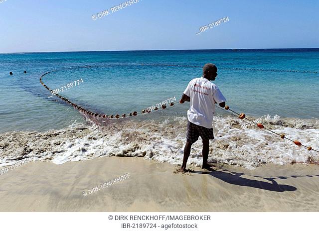 Fisherman with fishing net on the beach of Sao Pedro, Sao Vicente, Cape Verde, Africa