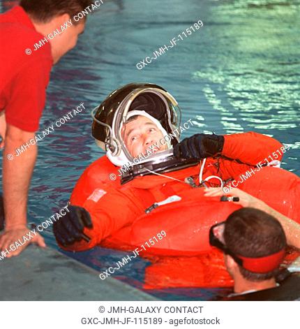 Astronaut Terrence W. (Terry) Wilcutt, STS-106 mission commander, talks with crew training staff members during a simulation of an emergency bailout exercise in...
