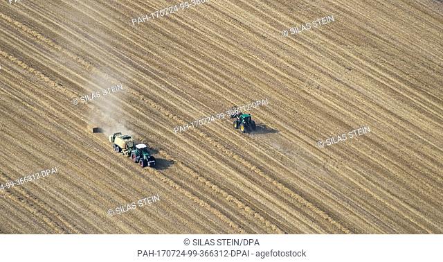 Farmers drive down grain fields with a combine harvester near Salzgitter, Germany, 19 July 2017.....(Aerial View taken with an ultralight aircraft) Photo: Silas...