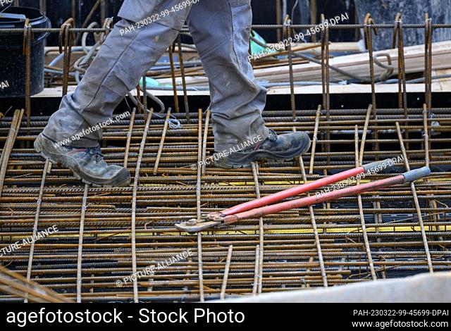22 March 2023, Saxony, Dresden: A construction worker walks along a reinforced concrete ceiling at the building site of the extension to the headquarters of...