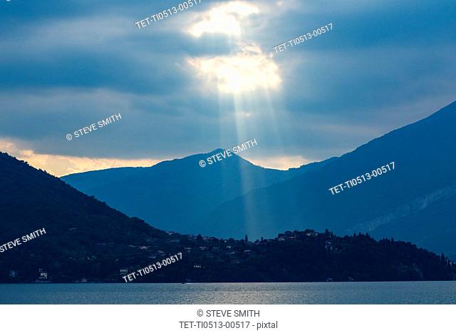 Sunbeams through clouds over Lake Como, Italy