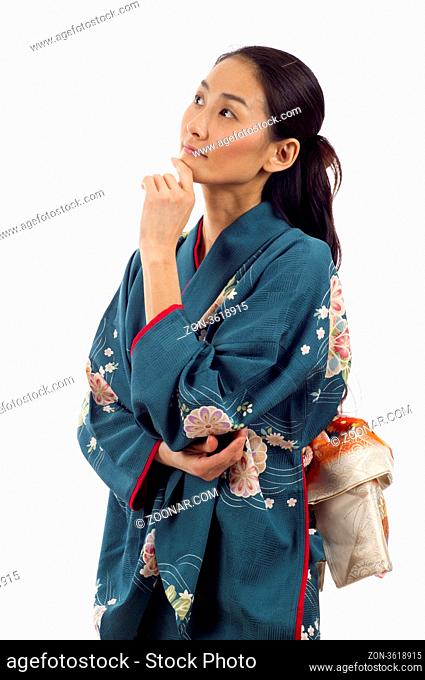 Beautiful thoughtful Japanese kimono woman looking up isolated over white background